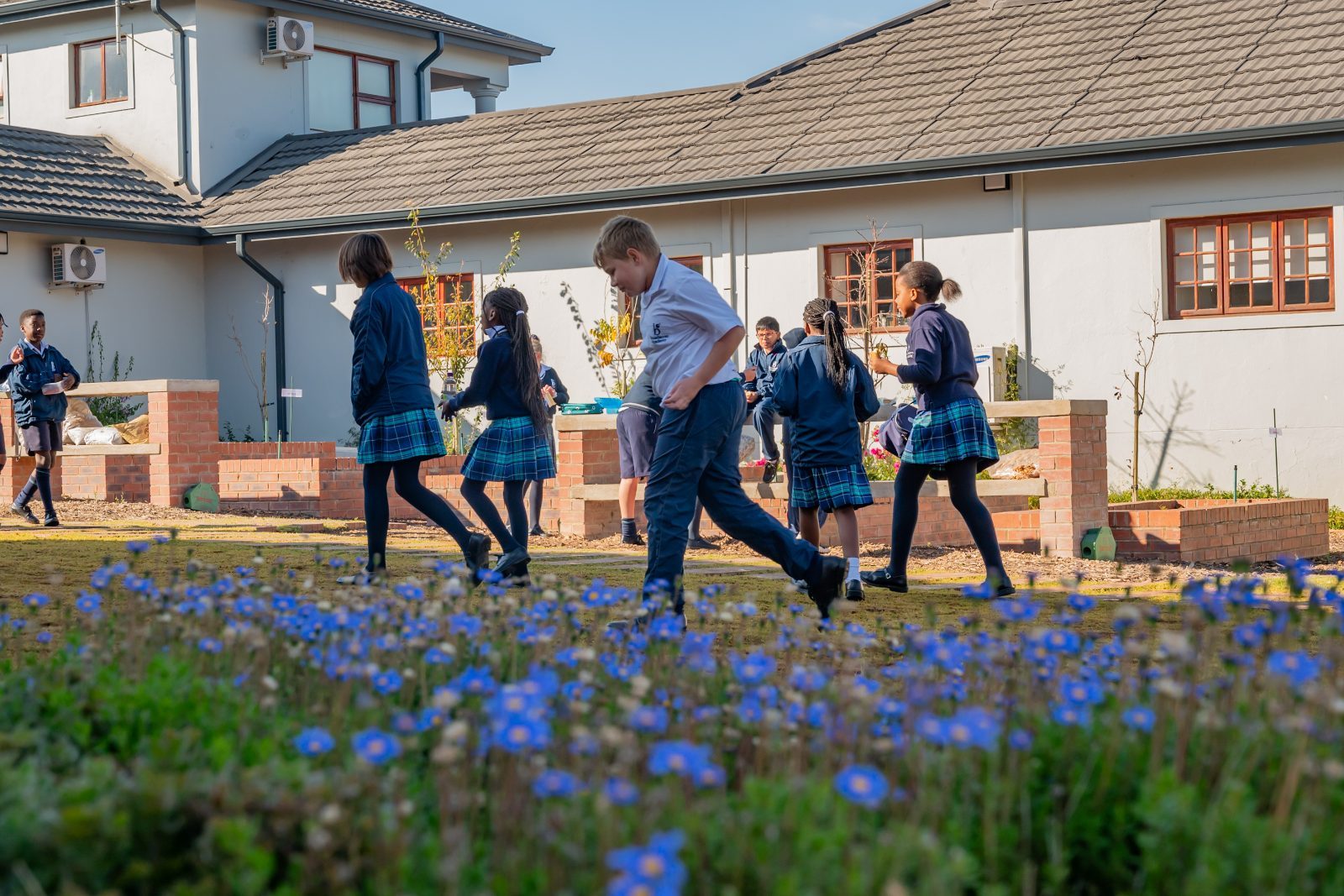 Broadacres pupils walking through the courtyard garden